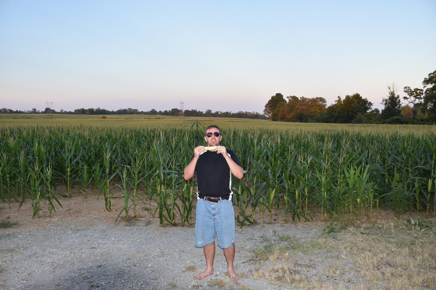 Steven eating fresh corn just picked.